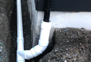 downspout drainage system repaired by sewer flow